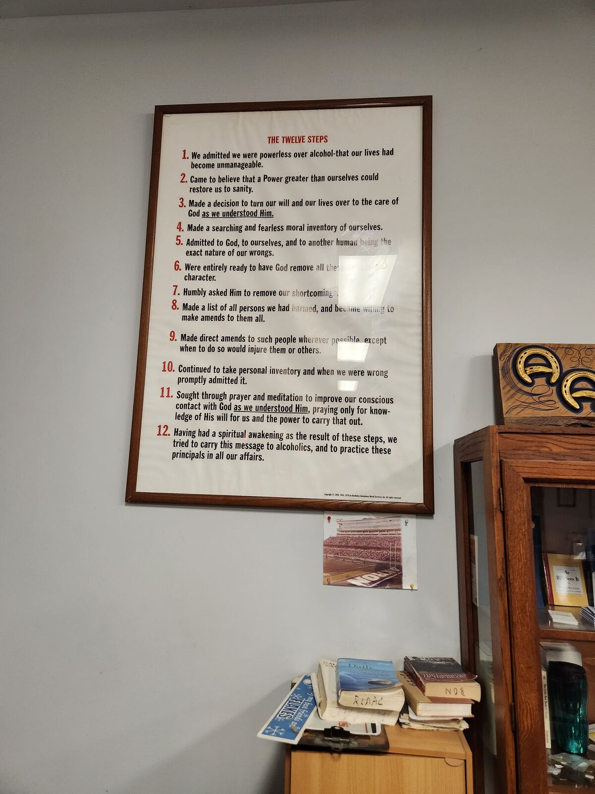 The Twelve Steps poster framed on the club wall